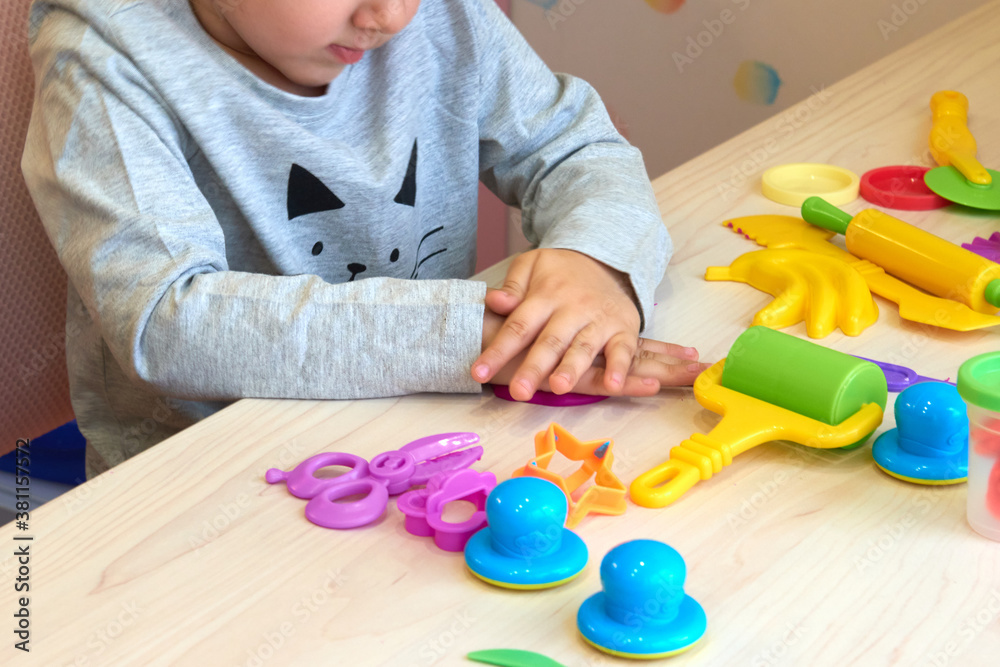 3 years girl creative arts. Child hands playing with colorful clay. Plasticine. play dough. Self-isolation Covid-19, online education, homeschooling. Toddler girl studying at home, home learning 3 years girl creative arts. Child hands playing with colorful clay. Plasticine. play dough. Self-isolation Covid-19, online education, homeschooling. Toddler girl studying at home, home learning