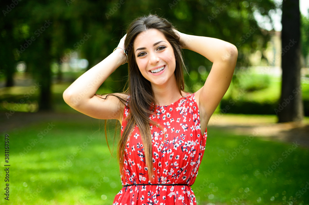 Portrait of a young beautiful woman outdoor in a park