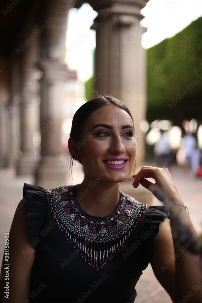 Fototapeta premium latin girl, student using cellphone while sitting in a coffee shop in mexico, queretaro beauty