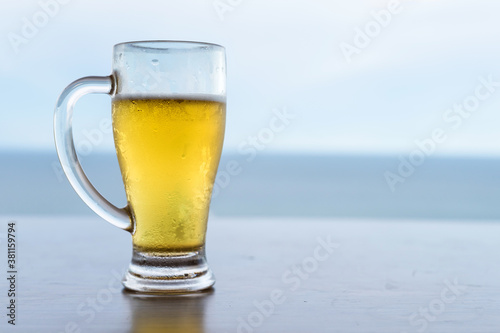 Fresh cold beer in glass with space for text