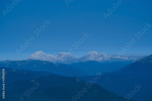 blurred abstract natural background with Caucasus Mountains in a morning blue mist