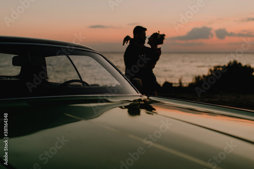 silhouette of a couple in love at sunset by the ocean