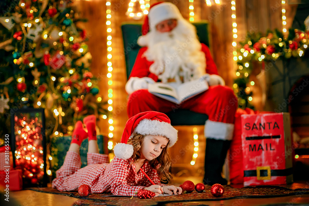 Merry Christmas, santa claus and little child girl at night at the Christmas tree. Merry Christmas, santa claus and little child girl at night at the Christmas tree.