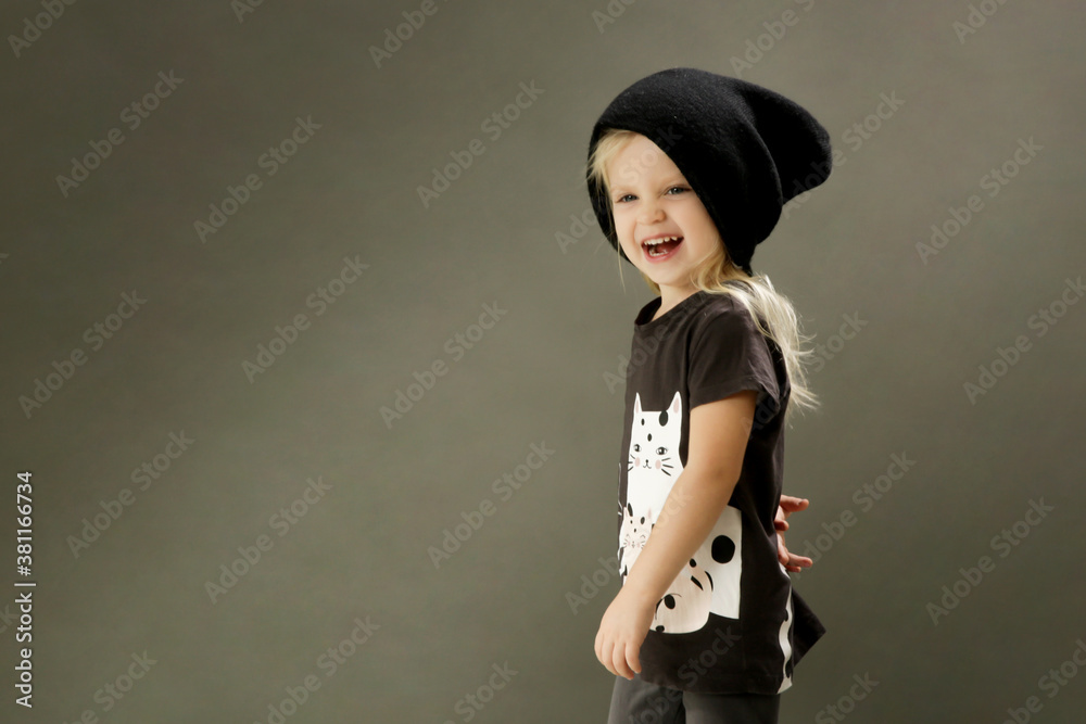 Studio shot of 3 years old fashionable kid on the grey background
Studio shot of 3 years old fashionable kid on the grey background