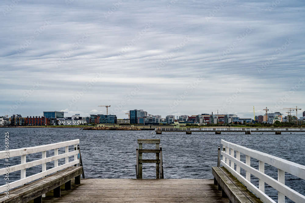 A wooden jetty with blue ocean and sky in the background. Picture from Malmo in southern Sweden A wooden jetty with blue ocean and sky in the background. Picture from Malmo in southern Sweden