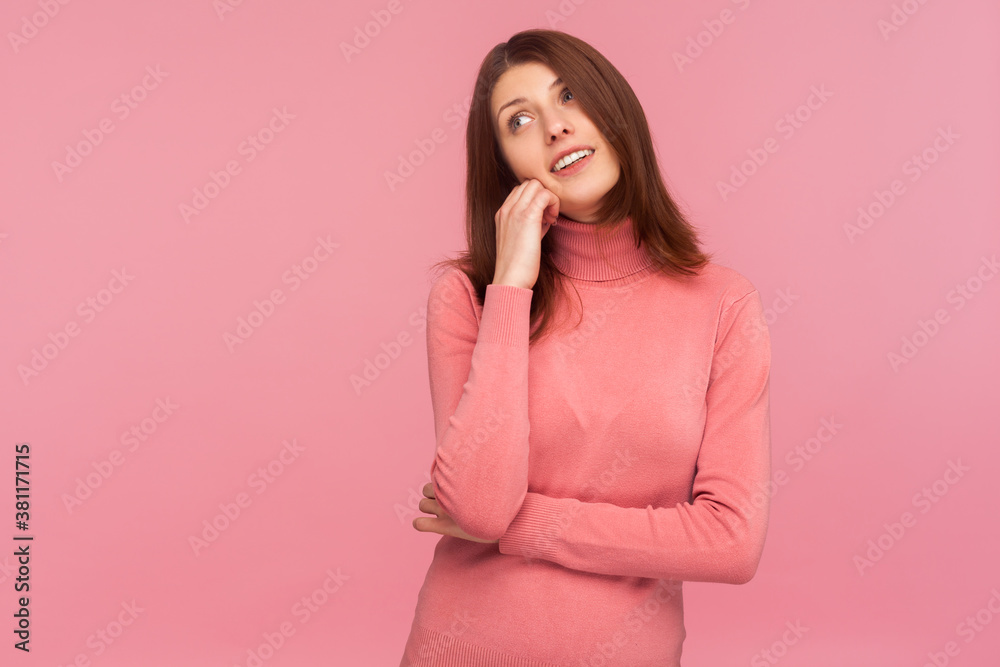 Dreamy optimistic brunette woman in pink sweater leaning head on hand imagining her perfect life, fantasizing. Indoor studio shot isolated on pink background Dreamy optimistic brunette woman in pink sweater leaning head on hand imagining her perfect life, fantasizing. Indoor studio shot isolated on pink background