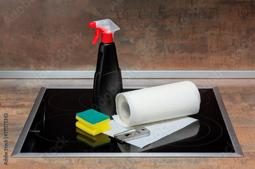 Still life of items for cleaning the surface of the electric stove