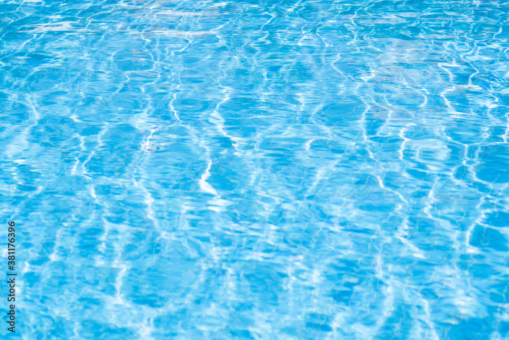 Texture of water in pool. Closeup of rough water surface texture with splashes. Waving water texture backdrop