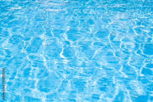 Texture of water in pool. Closeup of rough water surface texture with splashes. Waving water texture backdrop © Nataliia Karabin