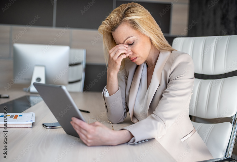 A business woman sits in her office and thinks about how to solve new problems that have arisen on a project run by her firm A business woman sits in her office and thinks about how to solve new problems that have arisen on a project run by her firm
