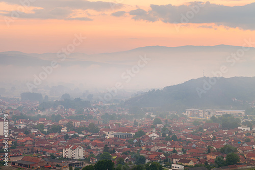 Soft view of Pirot city, Serbia, covered by mist and haze during sunset from a viewpoint