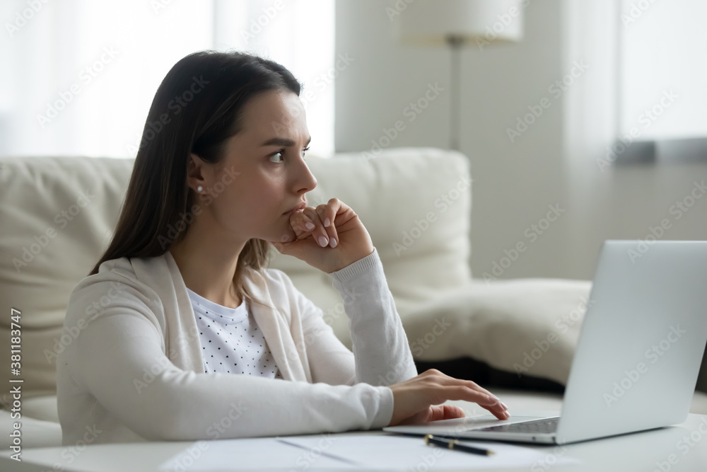 Thoughtful young Caucasian woman work on laptop at home look in distance solving problem issue. Pensive millennial female busy using computer pondering thinking over trouble solution. Dilemma concept Thoughtful young Caucasian woman work on laptop at home look in distance solving problem issue. Pensive millennial female busy using computer pondering thinking over trouble solution. Dilemma concept