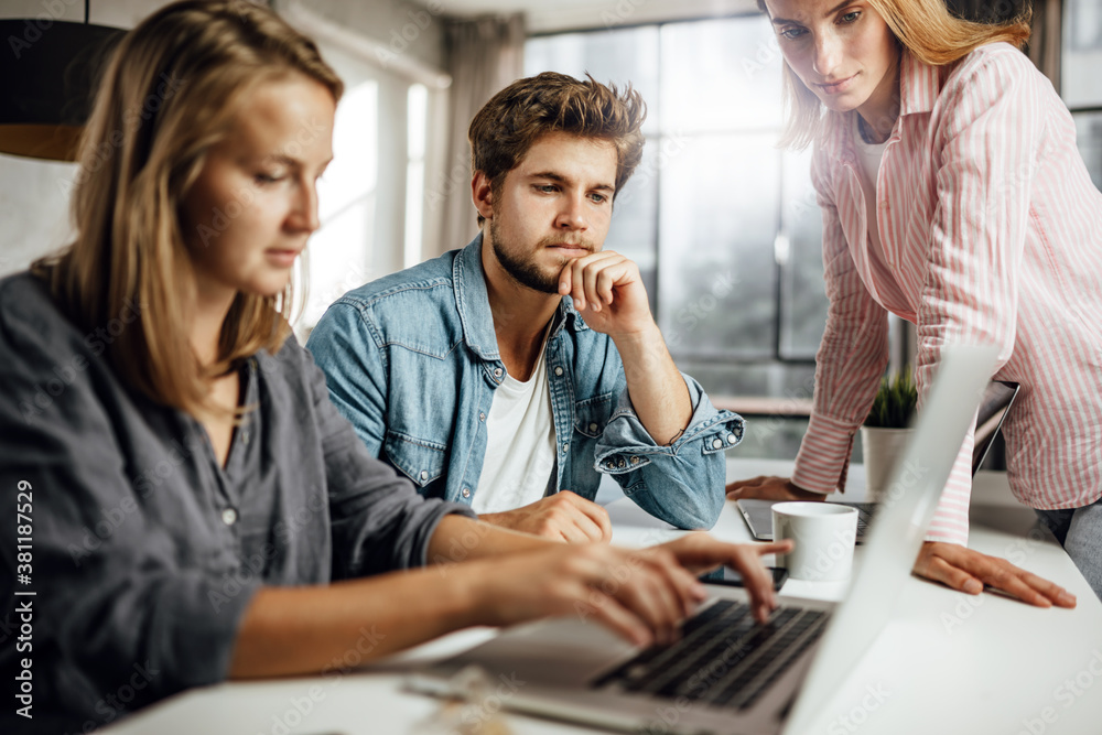 © Rymden - Group of young people working or studying together. Hipster team in coworking. Young modern business colleagues. Startup concept © Rymden - Group of young people working or studying together. Hipster team in coworking. Young modern business colleagues. Startup concept