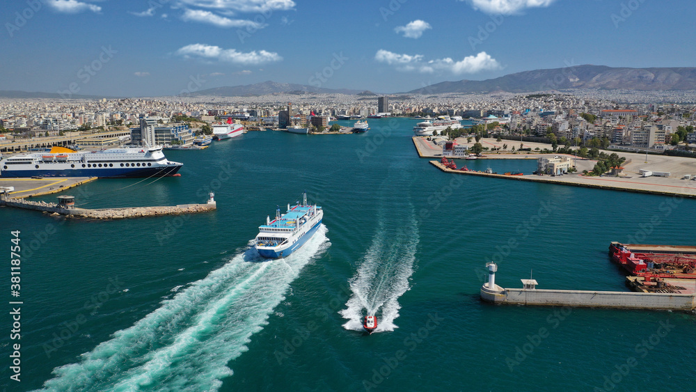 Aerial drone photo of passenger ferry cruising in high speed and entering famous port of Piraeus, Attica, Greece