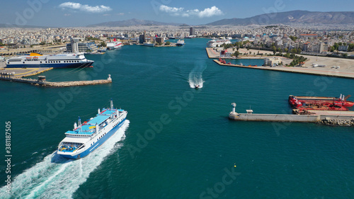 Aerial drone photo of passenger ferry cruising in high speed and entering famous port of Piraeus, Attica, Greece