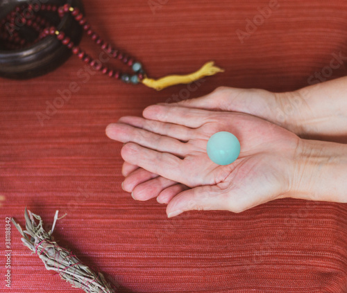 Unrecognizable woman holding in hand a quartz crystal