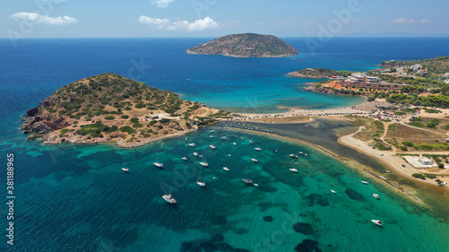 Aerial drone photo of famous islet, beach and bay of Agios Nikolaos in Anavysos area with crystal clear emerald sea, Athens riviera, Attica, Greece