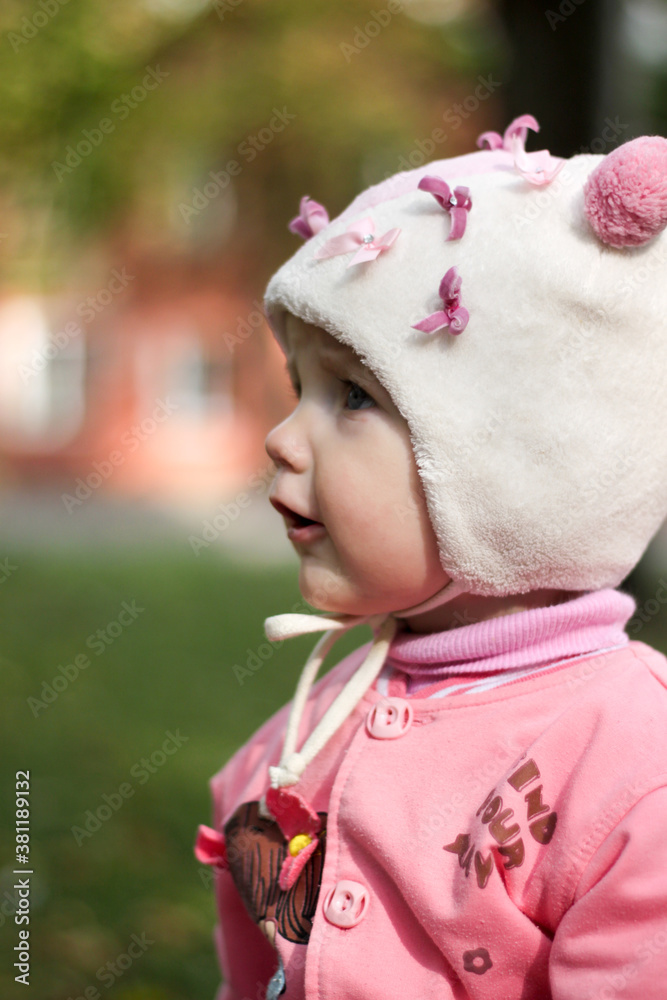 girl in pink clothes and a hat with ears close up