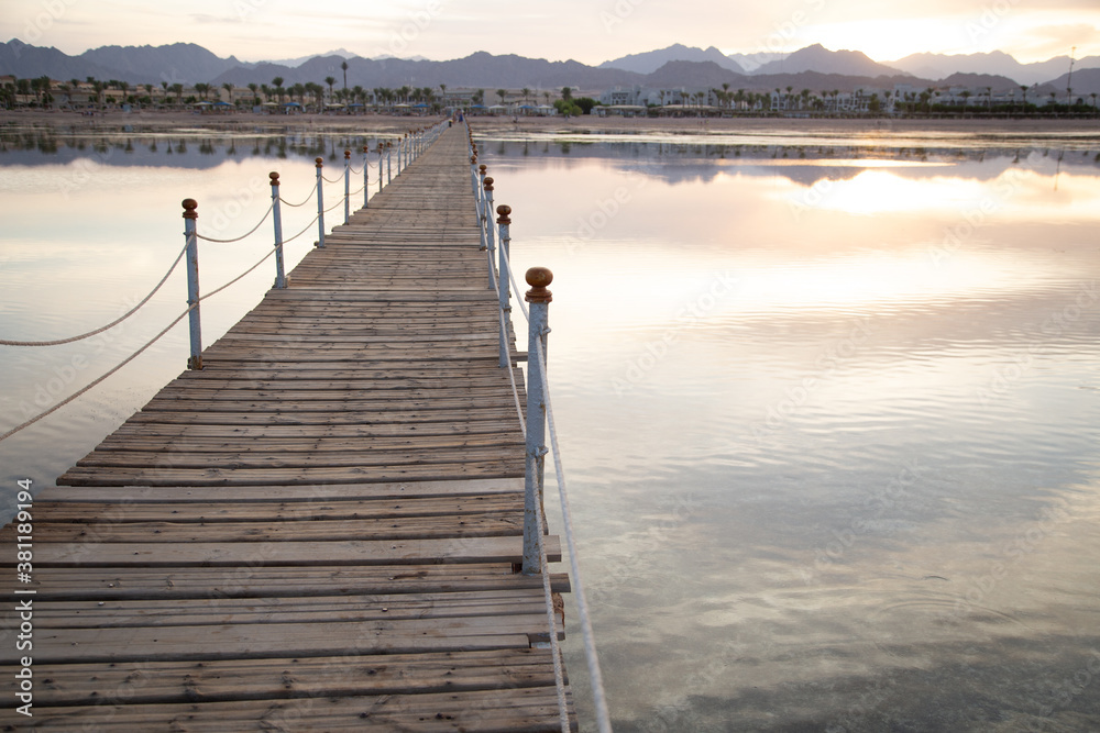 Fototapeta premium The background is a beautiful wooden long pier