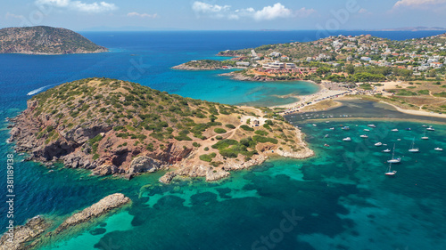 Aerial drone photo of famous islet, beach and bay of Agios Nikolaos in Anavysos area with crystal clear emerald sea, Athens riviera, Attica, Greece