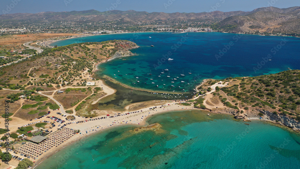 Aerial drone photo of famous islet, beach and bay of Agios Nikolaos in Anavysos area with crystal clear emerald sea, Athens riviera, Attica, Greece