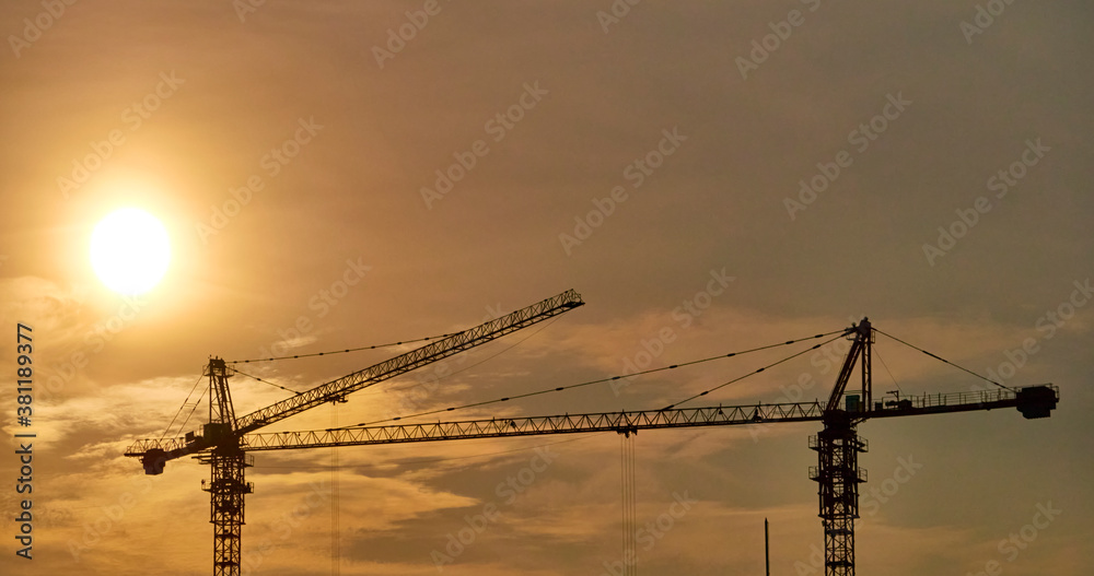 Construction crane on the background of a beautiful sky at sunset. general plan