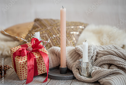 Cozy festive still life with a gift and a candle