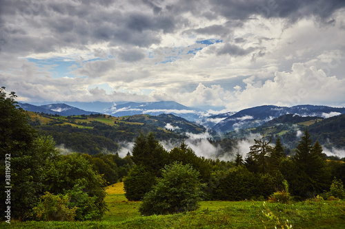 View from the Synevyr pass to the foggy mountains in National Natural Park Synevir, Mizhhirya district of the Transcarpathian region, Ukraine © bondvit