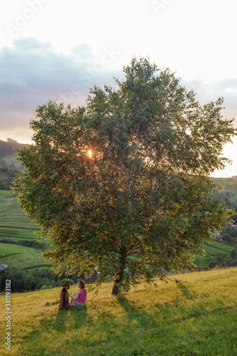 woman and dog in mountains at sunset