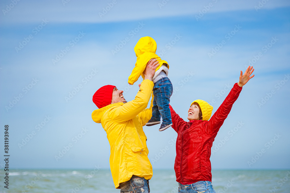 Happy Family on the seashore in colorful clothes.