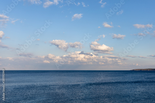 Calm sea landscape with beautiful clouds and mountains 