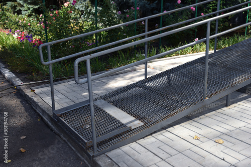 The ramp for the people with disabilities near administrative building, office, house. Improvement of the entrance with special equipment for disabled person wheelchair.