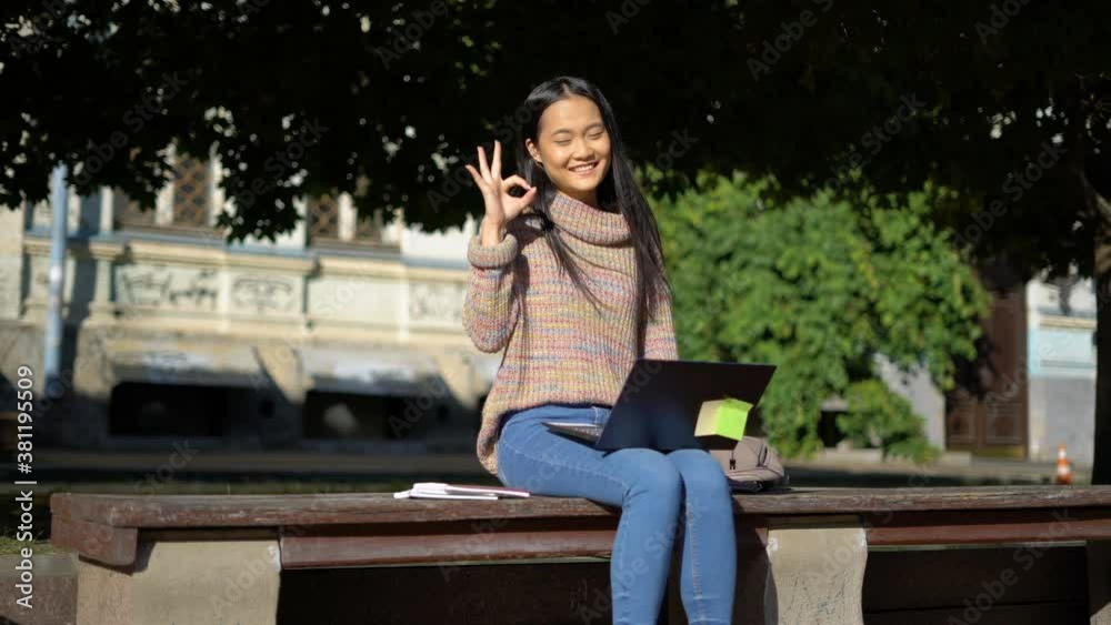 young asian woman shows OK gesture. young asian woman shows OK gesture.