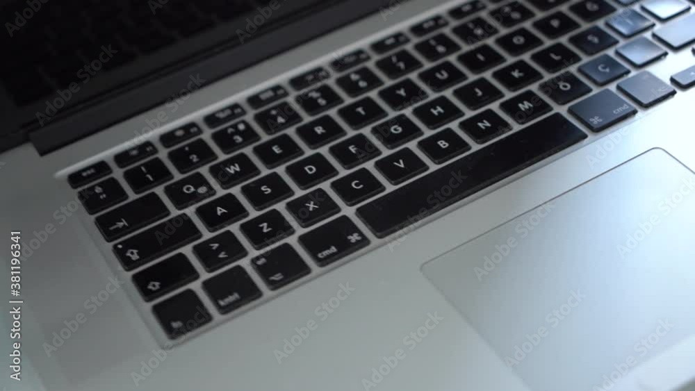 Close up view of simple workspace with laptop, smartphone, coffee cup and tree pot on white table with blurred office room background.