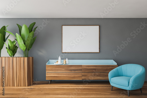 Fototapeta Naklejka Na Ścianę i Meble -  Stylish gray living room with blue armchair and poster