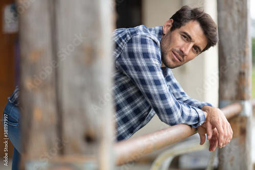 Fotografie close-up portrait of a handsome farmer indoors in the barn