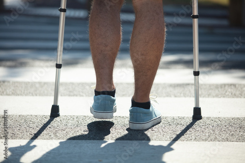 legs crossing crosswalk in city