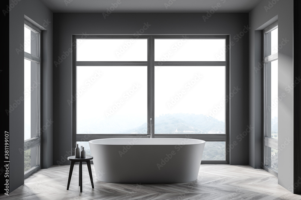 Stylish gray bathroom interior with tub and windows Stylish gray bathroom interior with tub and windows