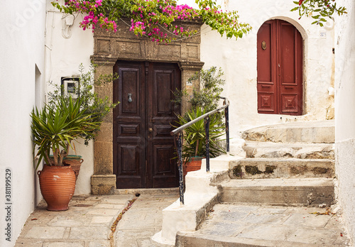 vintage wooden door on the old street of the village of Lindos, Greece 