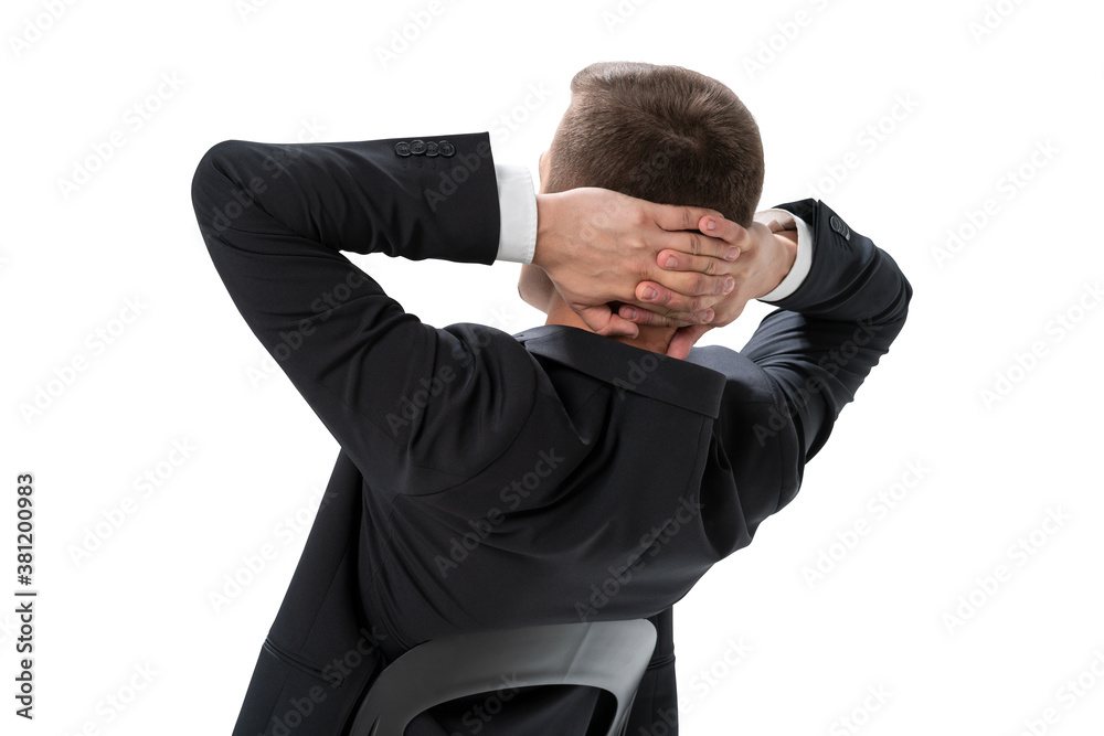 Relaxed young businessman sitting in armchair, isolated Relaxed young businessman sitting in armchair, isolated