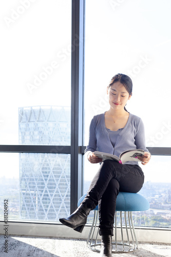 Young Chinese woman  reading in an office