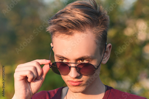 Young guy with glasses during evening sunset © Сергей Старостов