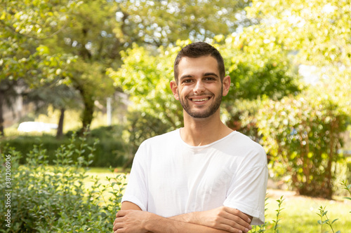 portrait of attractive young man with beard outdoors