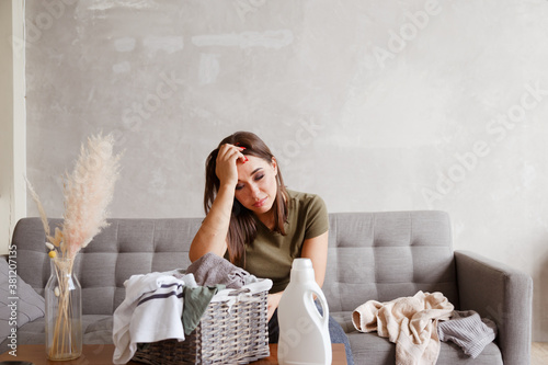 Young alone suffering woman tired from housework routine photo