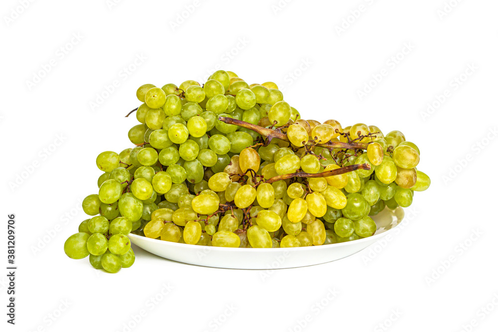 Bunches of green and yellow grapes on a white plate Bunches of green and yellow grapes on a white plate