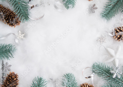 New Year's and Christmas layout of pine branches and decor in the snow with a copy space. Winter holidays flat lay