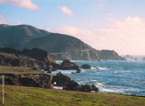 Bixby Bridge at sunset with Pacific Ocean waves crashing