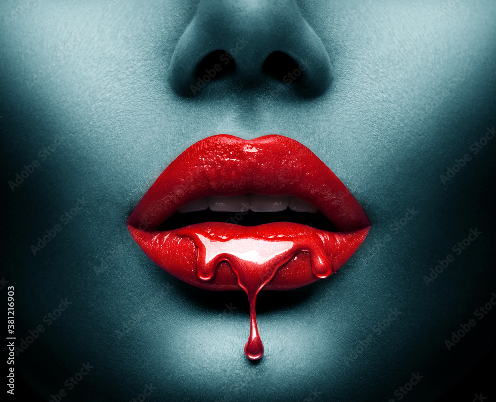 Red Paint dripping, lipgloss drops on sexy lips, bright liquid paint on beautiful model girl's mouth, Vampire. Halloween. Lipstick. Make-up. Beauty face makeup, close up. Isolated on black background - obrazy, fototapety, plakaty 
