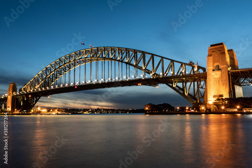 Iconic Sydney Harbour Bridge at sunset with blue sky 