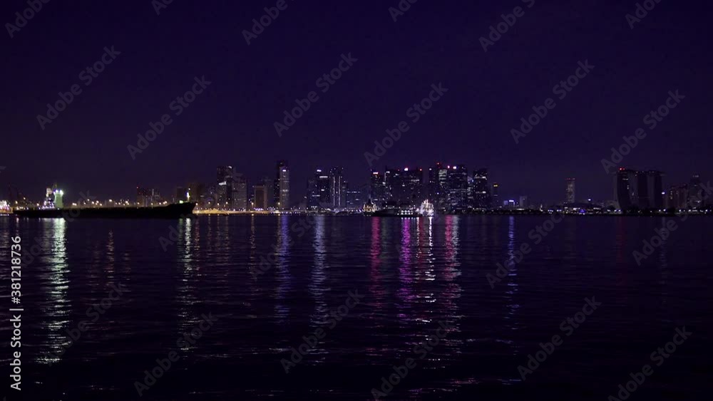 Lights of the night city of Singapore. Сity view from the sea. Financial district, office buildings, marina, city architecture, towers. Lights of the night city of Singapore. Сity view from the sea. Financial district, office buildings, marina, city architecture, towers.